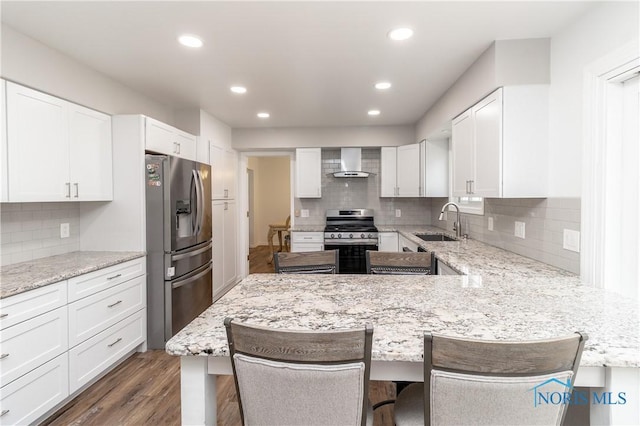 6842 Shieldwood Rd, Toledo, OH 43617 - kitchen with stainless steel appliances, wall chimney exhaust hood, tasteful backsplash, white cabinets, and recessed lighting