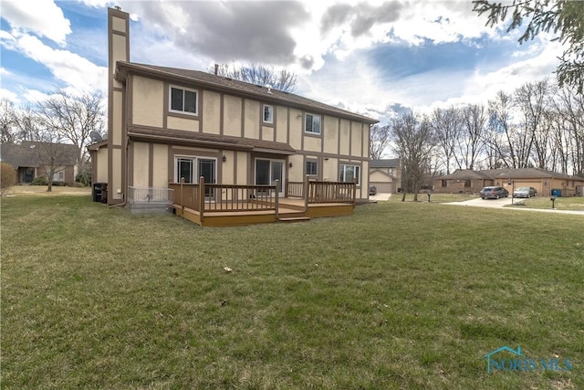 6842 Shieldwood Rd, Toledo, OH 43617 - rear view of house featuring a deck, a chimney, a lawn, and stucco siding