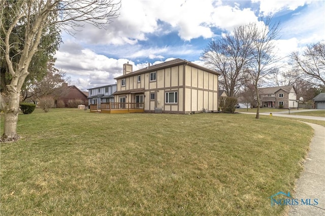 6842 Shieldwood Rd, Toledo, OH 43617 - view of front facade with a deck, a chimney, and a front yard