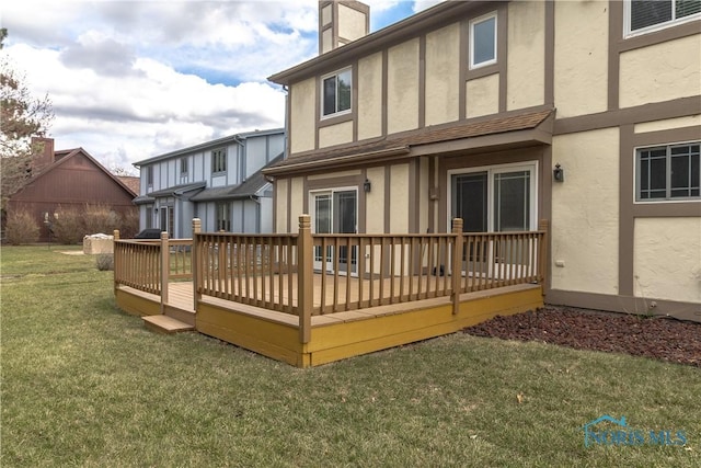 6842 Shieldwood Rd, Toledo, OH 43617 - rear view of property featuring stucco siding, a lawn, and a deck