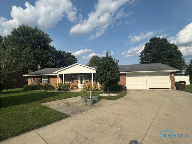 1549 Marcelle Ave, Findlay, OH 45840 - single story home featuring brick siding, concrete driveway, a front lawn, and an attached garage