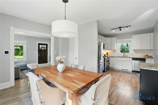 233 E 5th St, Perrysburg, OH 43551 - dining space with light wood-style floors and baseboards