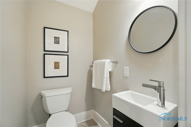233 E 5th St, Perrysburg, OH 43551 - half bathroom featuring baseboards and vanity