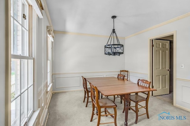 5941 Indian Trl, Sylvania, OH 43560 - dining room featuring ornamental molding, a chandelier, light colored carpet, wainscoting, and a decorative wall