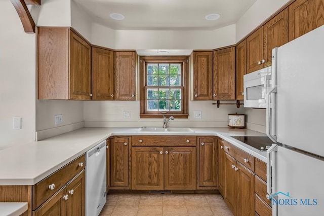 5941 Indian Trl, Sylvania, OH 43560 - kitchen with white appliances, brown cabinetry, light countertops, and light tile patterned flooring