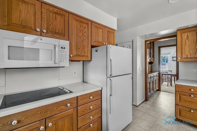 5941 Indian Trl, Sylvania, OH 43560 - kitchen with white appliances, brown cabinets, and light countertops