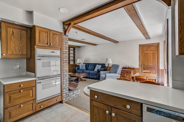5941 Indian Trl, Sylvania, OH 43560 - kitchen with white appliances, beam ceiling, light countertops, brown cabinetry, and open floor plan