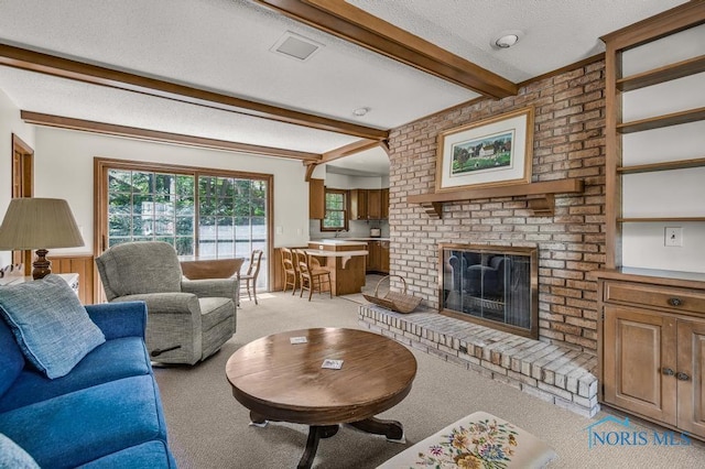 5941 Indian Trl, Sylvania, OH 43560 - living area featuring beamed ceiling, light carpet, a textured ceiling, and a brick fireplace