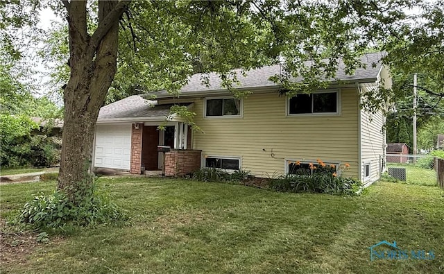 813 Maple Ln, Waterville, OH 43566 - rear view of property with a garage and a shingled roof