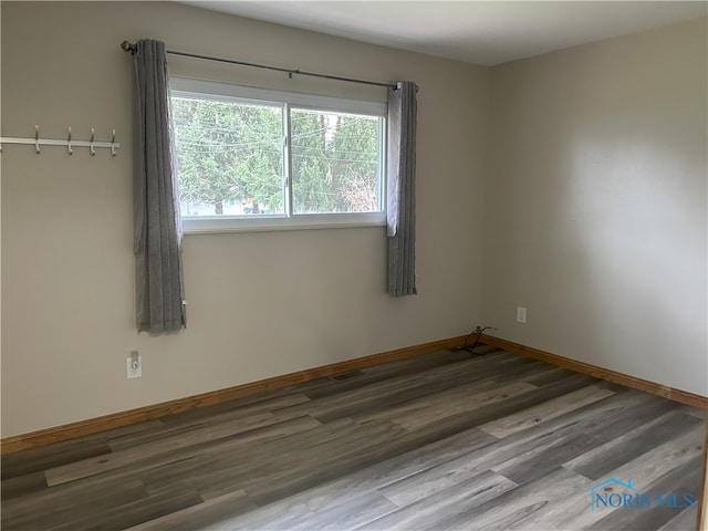 813 Maple Ln, Waterville, OH 43566 - unfurnished room featuring wood finished floors and baseboards