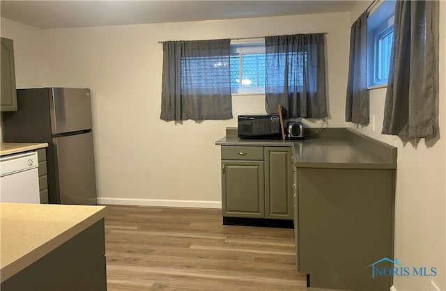 813 Maple Ln, Waterville, OH 43566 - kitchen with dishwasher, light wood-style flooring, freestanding refrigerator, black microwave, and gray cabinets