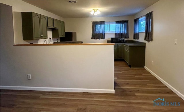 813 Maple Ln, Waterville, OH 43566 - kitchen featuring dark wood-style floors, refrigerator, and black microwave