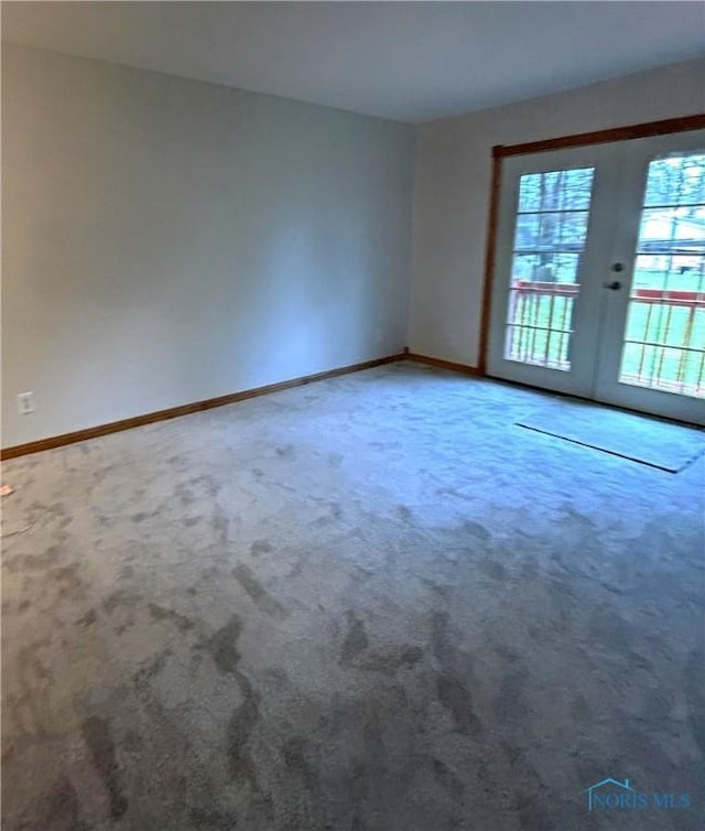 813 Maple Ln, Waterville, OH 43566 - empty room featuring carpet floors and french doors