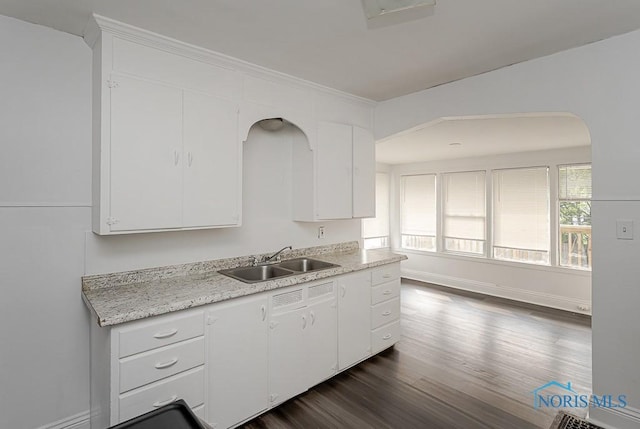 708 Spencer St, Toledo, OH 43609 - kitchen featuring light countertops, dark wood finished floors, and white cabinetry