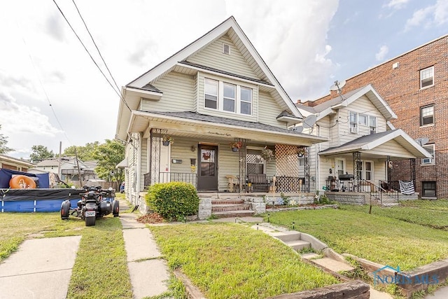 708 Spencer St, Toledo, OH 43609 - view of front facade featuring covered porch and a front yard
