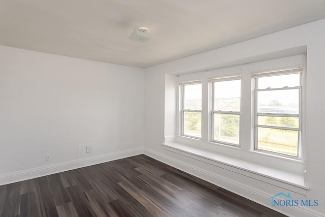 708 Spencer St, Toledo, OH 43609 - spare room featuring baseboards and dark wood-style floors