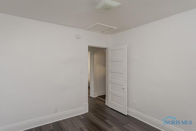 708 Spencer St, Toledo, OH 43609 - empty room featuring dark wood-style flooring, a smoke detector, and attic access