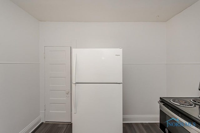 708 Spencer St, Toledo, OH 43609 - kitchen featuring freestanding refrigerator, dark wood-type flooring, and electric range oven