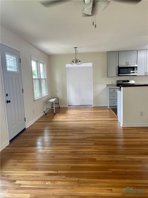 4846 Amesbury Rd, Toledo, OH 43612 - unfurnished living room featuring ceiling fan and light wood-type flooring