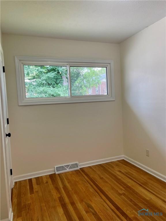 4846 Amesbury Rd, Toledo, OH 43612 - spare room featuring baseboards and wood finished floors