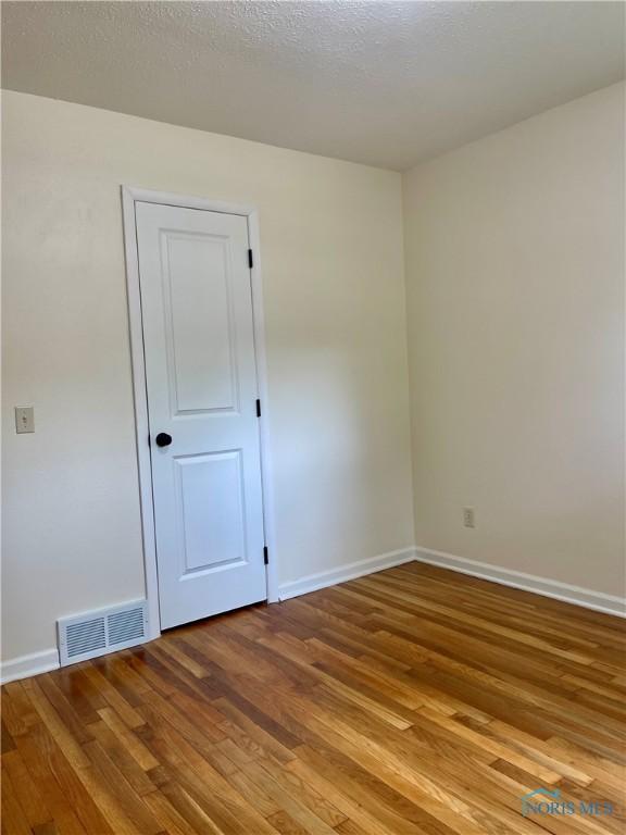 4846 Amesbury Rd, Toledo, OH 43612 - spare room featuring wood finished floors and a textured ceiling