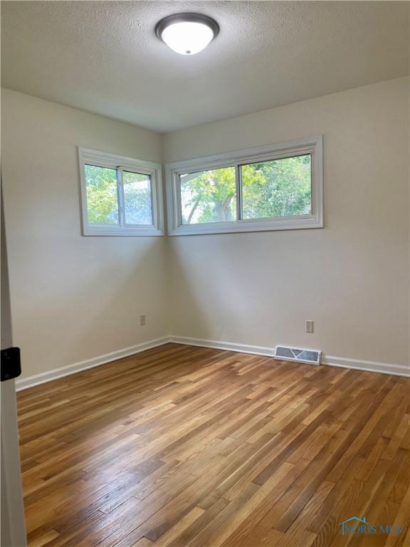 4846 Amesbury Rd, Toledo, OH 43612 - empty room featuring wood finished floors and a textured ceiling