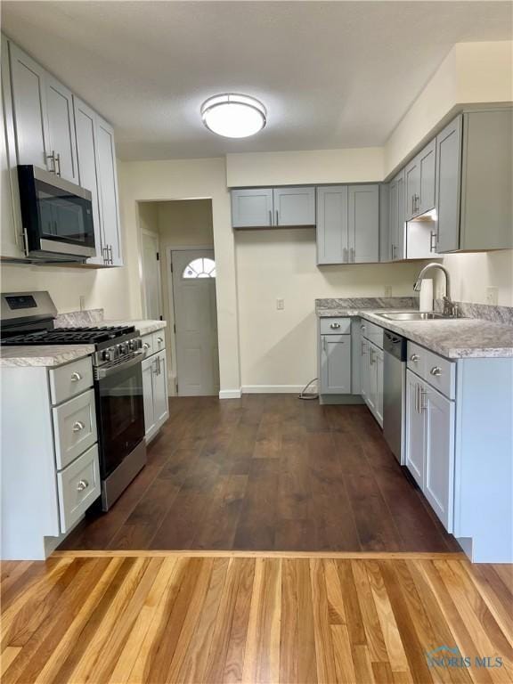 4846 Amesbury Rd, Toledo, OH 43612 - kitchen featuring appliances with stainless steel finishes, dark wood-style flooring, and gray cabinets