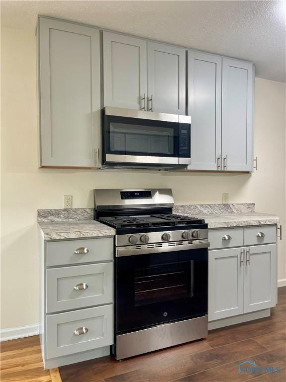 4846 Amesbury Rd, Toledo, OH 43612 - kitchen with stainless steel appliances, dark wood finished floors, light countertops, and gray cabinets