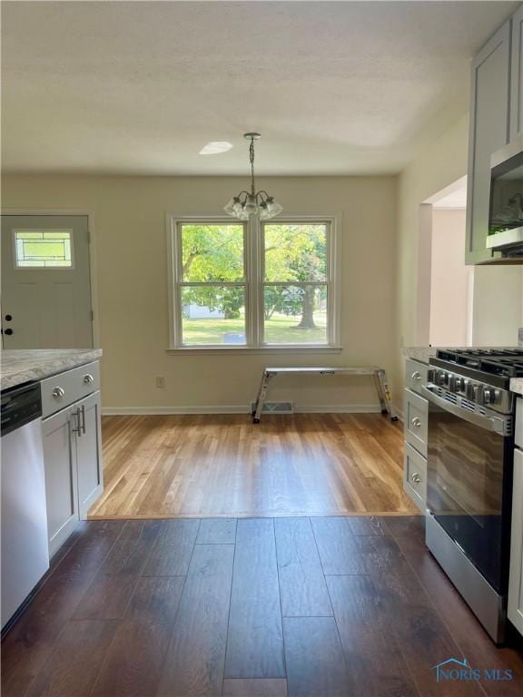 4846 Amesbury Rd, Toledo, OH 43612 - kitchen with appliances with stainless steel finishes, healthy amount of natural light, and dark wood-style flooring