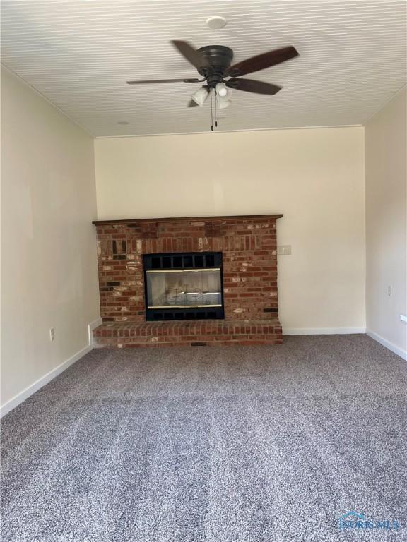 4846 Amesbury Rd, Toledo, OH 43612 - unfurnished living room featuring carpet flooring, a ceiling fan, and a brick fireplace