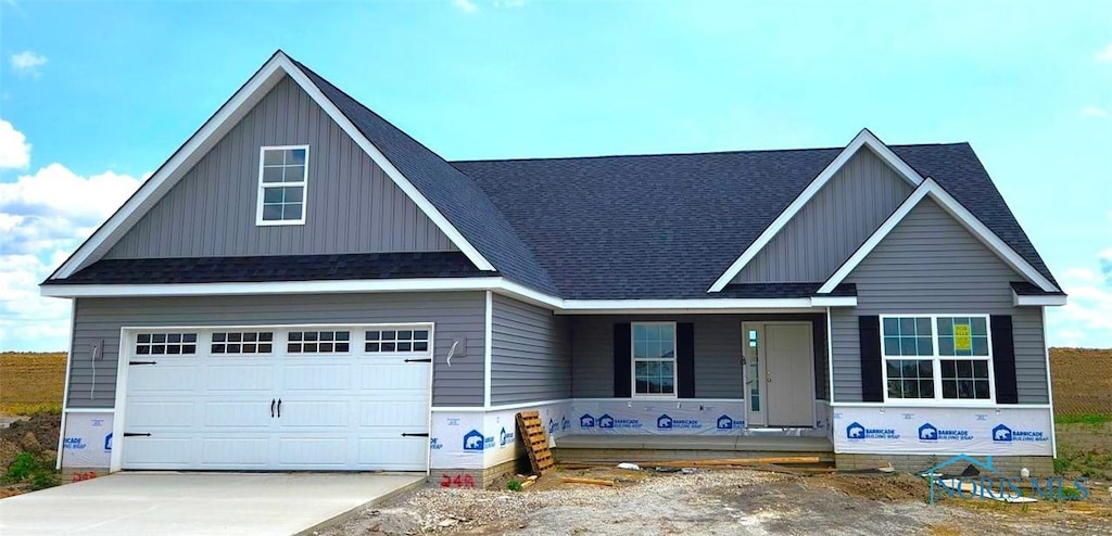 15261 Cypress Dr, Perrysburg, OH 43551 - view of front of home with a porch, board and batten siding, concrete driveway, and a shingled roof
