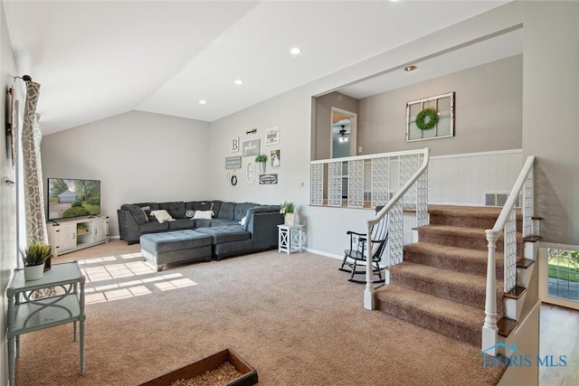 12982 State Route 34, Bryan, OH 43506 - carpeted living room with stairs, recessed lighting, vaulted ceiling, and wainscoting