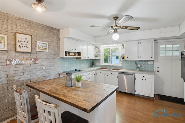 12982 State Route 34, Bryan, OH 43506 - kitchen featuring stainless steel dishwasher, open shelves, tasteful backsplash, and white cabinetry