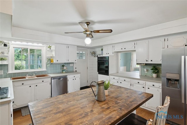12982 State Route 34, Bryan, OH 43506 - kitchen featuring appliances with stainless steel finishes, open shelves, backsplash, and white cabinets