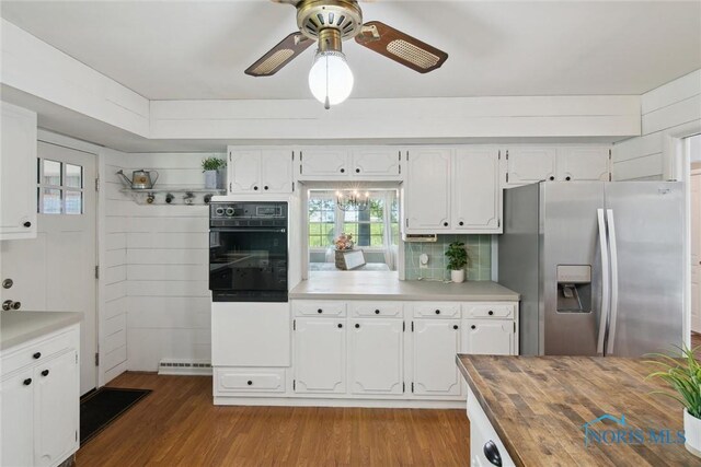12982 State Route 34, Bryan, OH 43506 - kitchen with stainless steel fridge with ice dispenser, oven, wooden counters, light wood-type flooring, and ceiling fan
