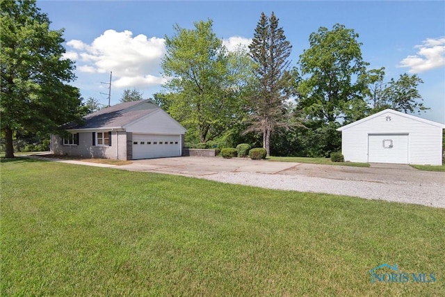 12982 State Route 34, Bryan, OH 43506 - view of grassy yard featuring a detached garage and an outdoor structure