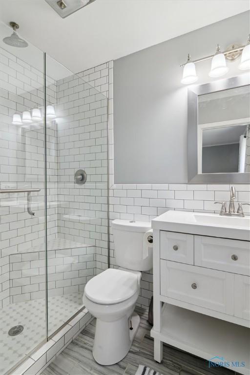 12982 State Route 34, Bryan, OH 43506 - bathroom with tile walls, a shower stall, and vanity