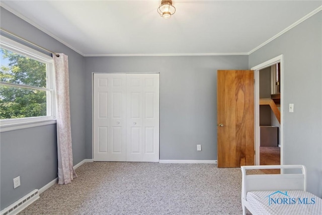 12982 State Route 34, Bryan, OH 43506 - unfurnished bedroom with a closet, carpet, crown molding, and baseboard heating