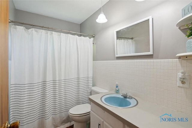 12982 State Route 34, Bryan, OH 43506 - full bathroom with tile walls, vanity, a wainscoted wall, and a shower with curtain