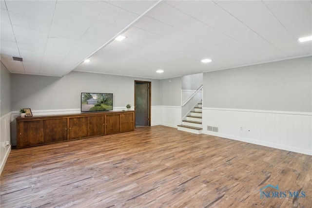 12982 State Route 34, Bryan, OH 43506 - below grade area with wainscoting, wood finished floors, stairs, and recessed lighting