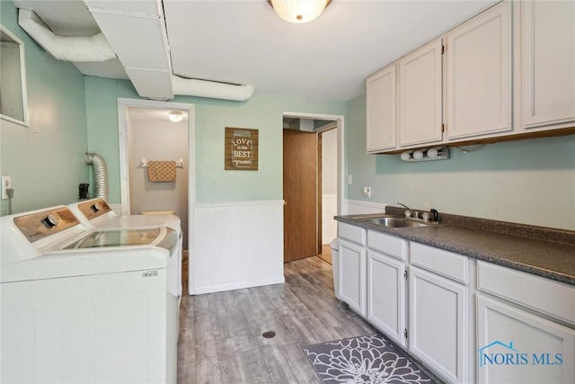 12982 State Route 34, Bryan, OH 43506 - washroom with washer and dryer, cabinet space, and light wood finished floors