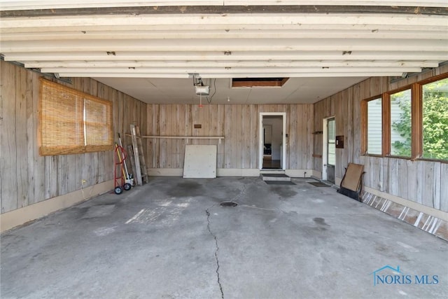 12982 State Route 34, Bryan, OH 43506 - garage with a garage door opener and wood walls