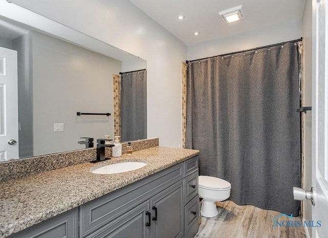 5157 Brinthaven Dr, Sylvania, OH 43560 - full bathroom featuring vanity, wood finished floors, and recessed lighting
