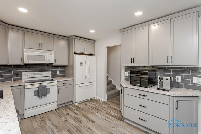 5157 Brinthaven Dr, Sylvania, OH 43560 - kitchen with white appliances, gray cabinets, tasteful backsplash, light wood-type flooring, and recessed lighting