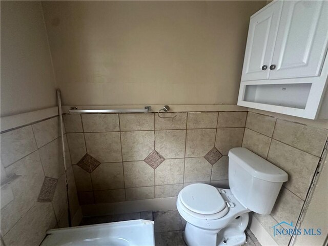1749 Berdan Ave, Toledo, OH 43613 - bathroom with tile walls, tiled shower, and a wainscoted wall