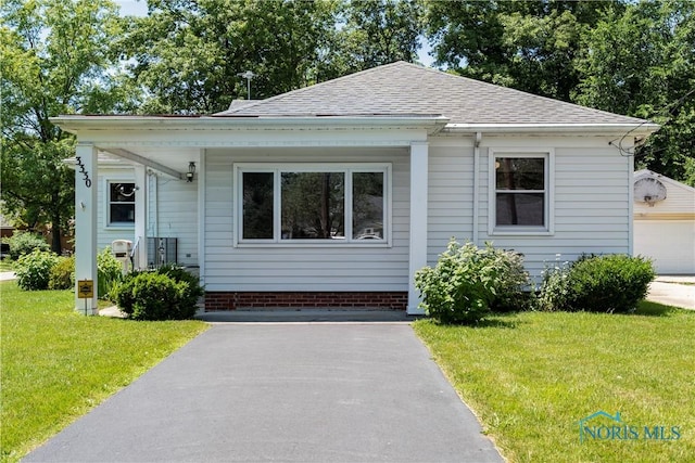 3328 Island Ave, Toledo, OH 43614 - bungalow featuring a front lawn and a shingled roof