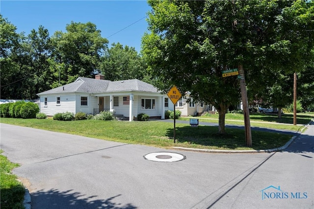3328 Island Ave, Toledo, OH 43614 - ranch-style home with a front lawn and a chimney