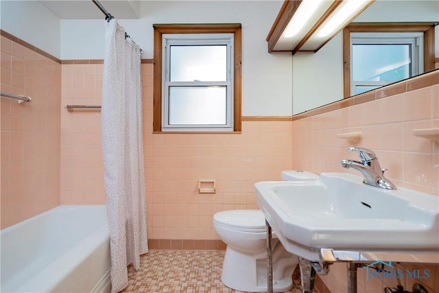 3328 Island Ave, Toledo, OH 43614 - bathroom featuring tile walls, healthy amount of natural light, shower / tub combo with curtain, and wainscoting