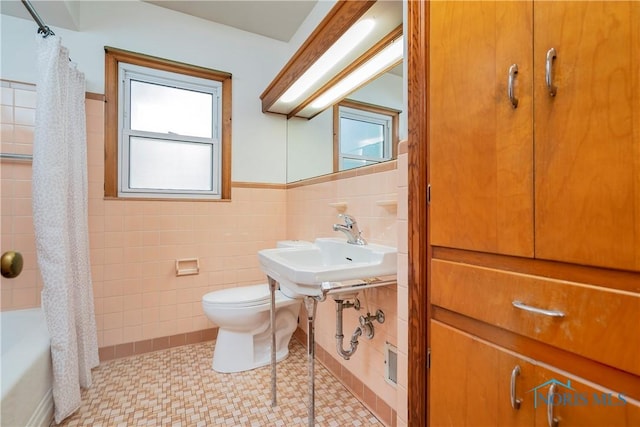 3328 Island Ave, Toledo, OH 43614 - bathroom with tile walls, shower / bath combination with curtain, and wainscoting