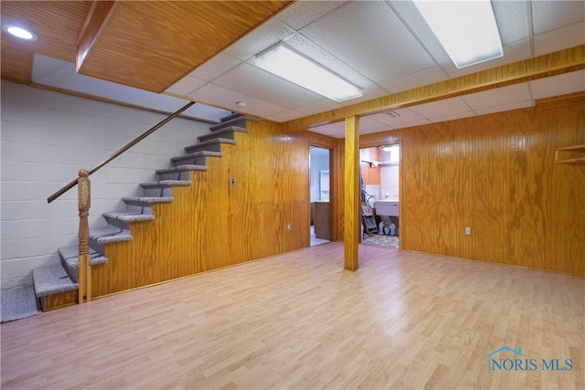 3328 Island Ave, Toledo, OH 43614 - finished basement with stairs, wood finished floors, a paneled ceiling, and wooden walls